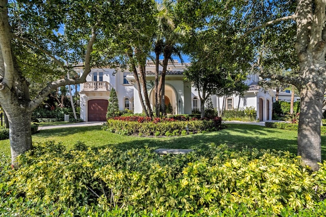 mediterranean / spanish-style home featuring a front lawn