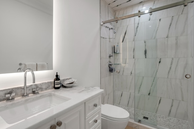 bathroom with walk in shower, vanity, and toilet