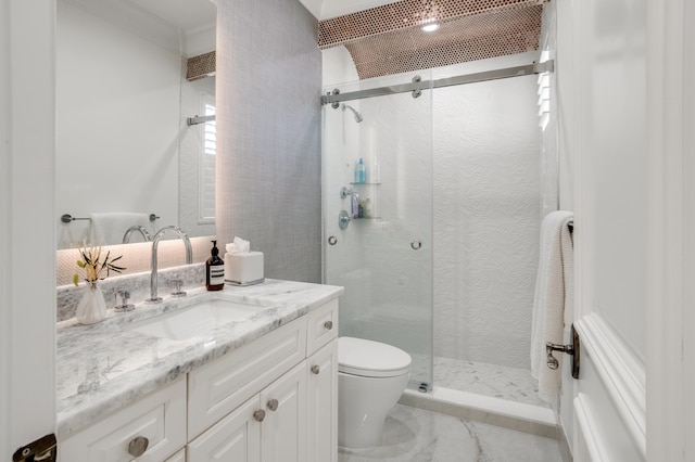 bathroom with a shower with door, vanity, and toilet