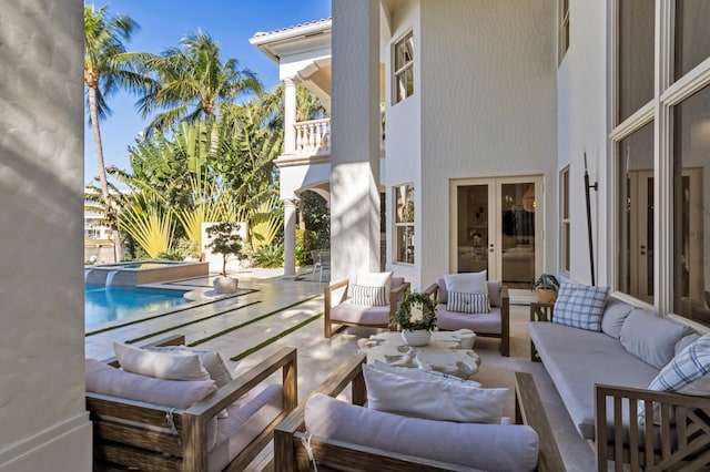 view of patio / terrace with a pool with hot tub, an outdoor hangout area, and french doors