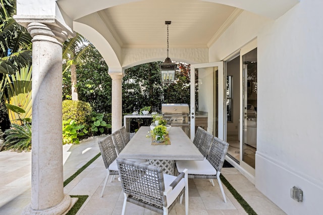 view of patio featuring exterior kitchen and a grill