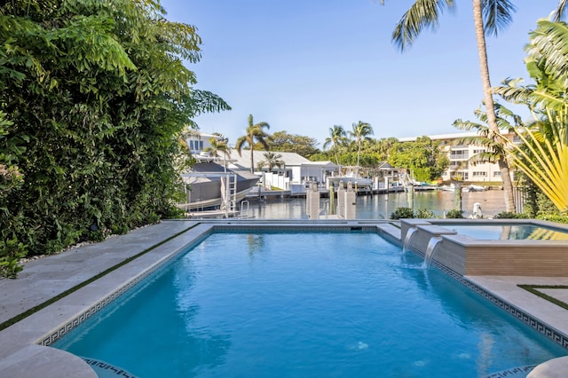 view of swimming pool featuring an in ground hot tub, pool water feature, and a water view