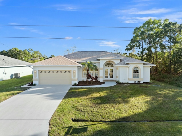 view of front of house featuring a front yard, french doors, and a garage