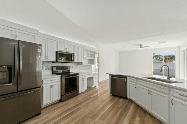 unfurnished dining area featuring high vaulted ceiling, a notable chandelier, and light hardwood / wood-style floors