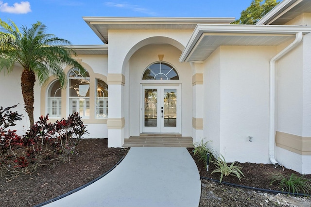 view of exterior entry featuring french doors