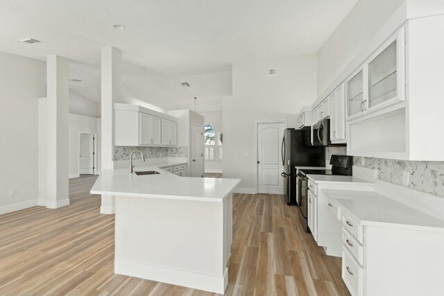 kitchen featuring ceiling fan, dishwasher, pendant lighting, sink, and white cabinetry