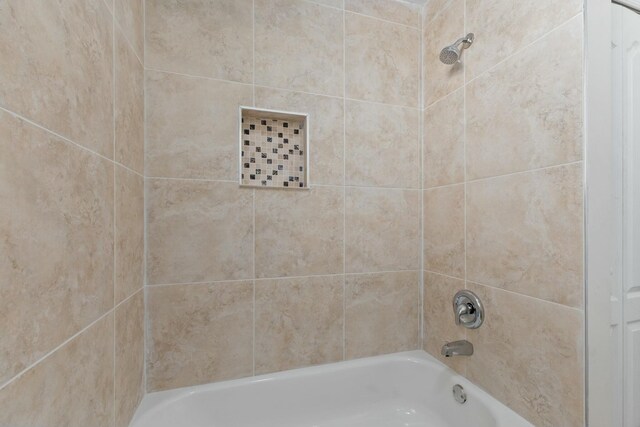 full bathroom with toilet, tiled shower / bath combo, and vanity