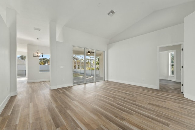 unfurnished room featuring hardwood / wood-style floors, plenty of natural light, and high vaulted ceiling