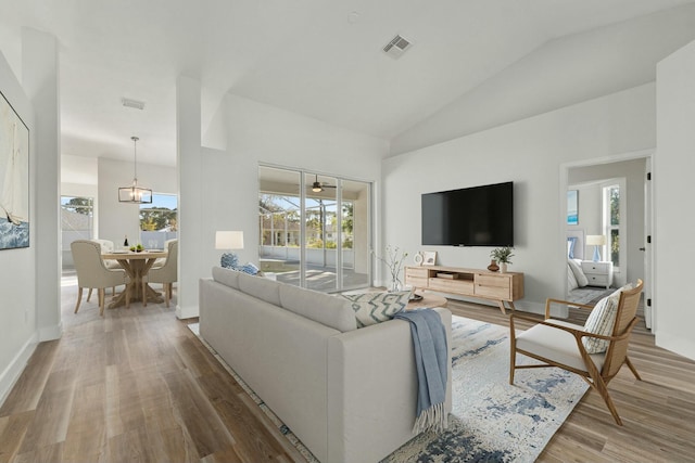 living room with wood-type flooring and vaulted ceiling