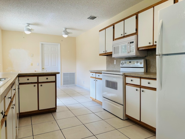 kitchen featuring light tile patterned floors, white cabinetry, kitchen peninsula, ceiling fan, and white appliances