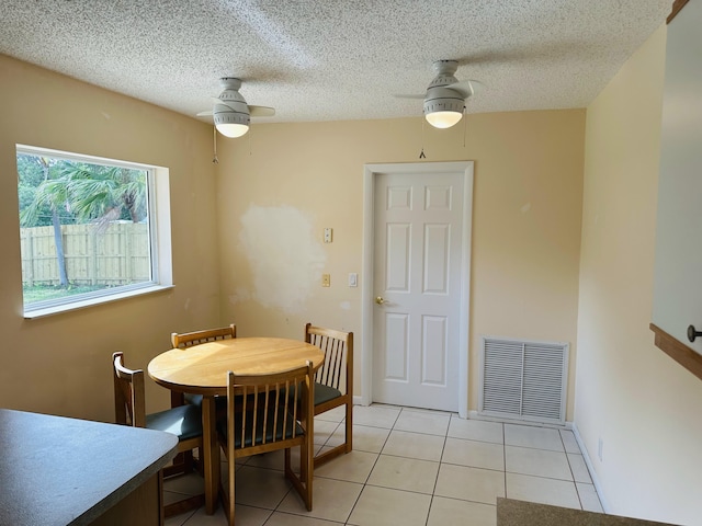 dining space featuring ceiling fan and light tile patterned floors