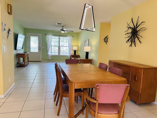 tiled dining area with ceiling fan