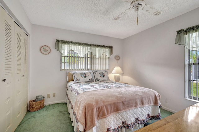 carpeted bedroom featuring ceiling fan, a textured ceiling, and a closet