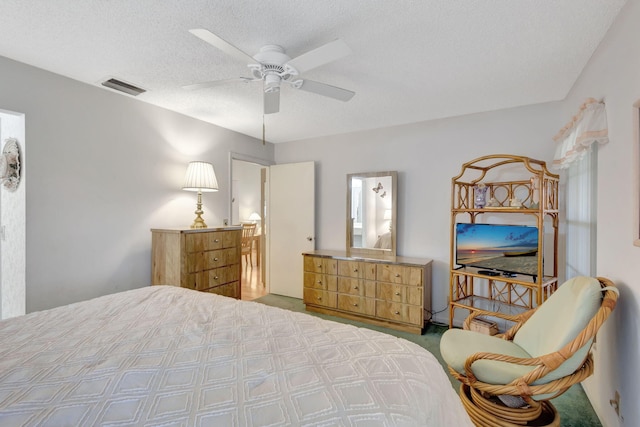 bedroom with ceiling fan and a textured ceiling