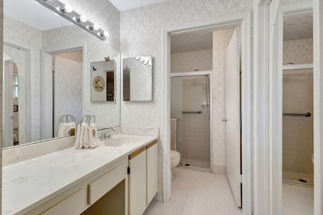 bathroom featuring toilet, tile patterned flooring, a shower with shower door, and vanity