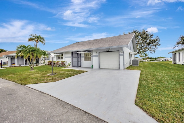 ranch-style house featuring a garage, a front lawn, and central air condition unit