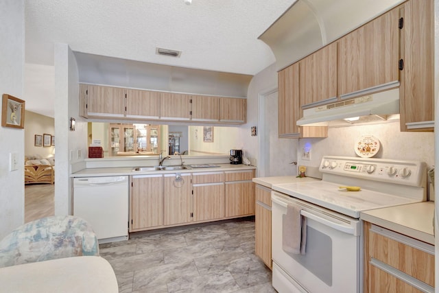 kitchen featuring light brown cabinets, sink, white appliances, and a textured ceiling