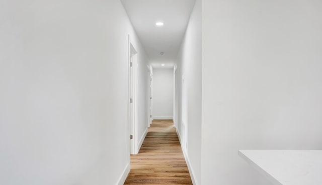 hallway with light hardwood / wood-style flooring