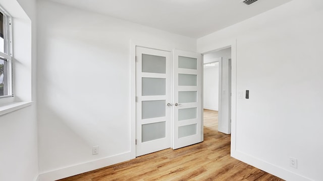 spare room with light hardwood / wood-style flooring