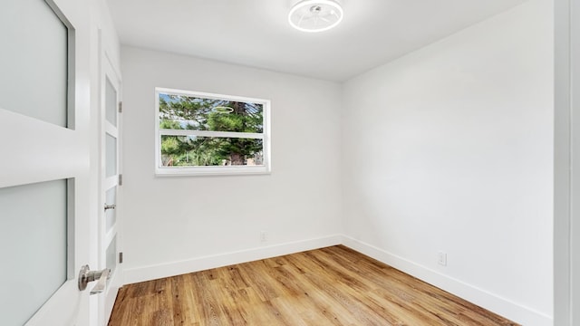 empty room with hardwood / wood-style flooring