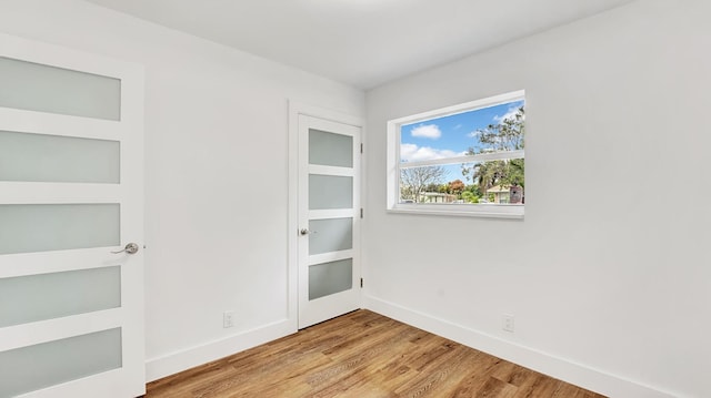 empty room with light hardwood / wood-style flooring