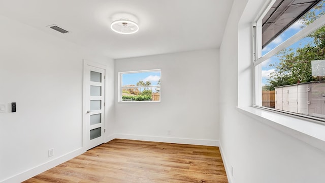 empty room with light hardwood / wood-style flooring