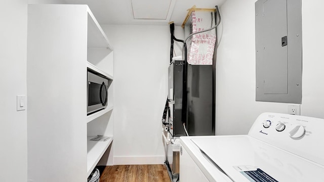 clothes washing area featuring electric panel, washer / dryer, and hardwood / wood-style floors