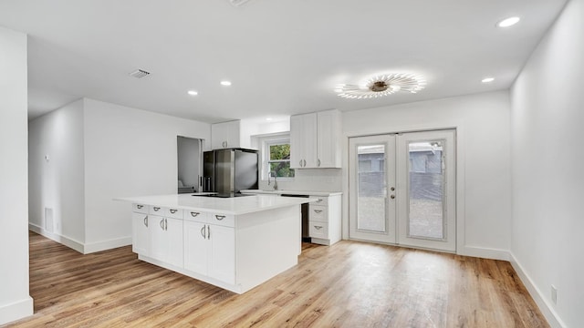 kitchen featuring white cabinetry, fridge with ice dispenser, french doors, light hardwood / wood-style floors, and a kitchen island