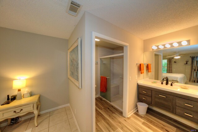 bedroom with ceiling fan, a closet, and hardwood / wood-style flooring