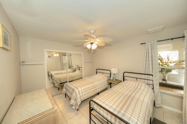 bedroom with ceiling fan and light tile patterned floors