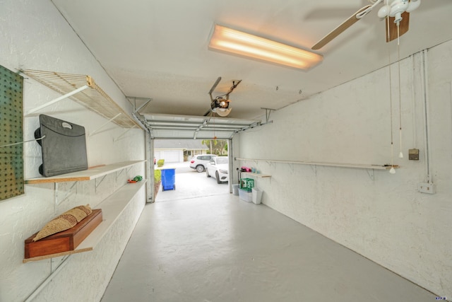 garage with ceiling fan and a garage door opener