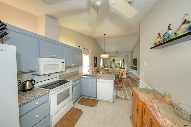 kitchen featuring kitchen peninsula, ceiling fan, white appliances, hanging light fixtures, and sink