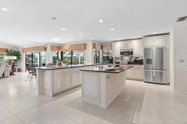 kitchen featuring stainless steel appliances, a center island, and light tile patterned floors