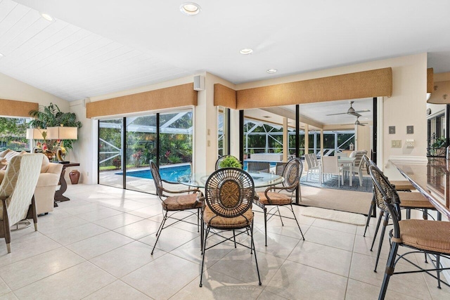 tiled dining room featuring vaulted ceiling and ceiling fan