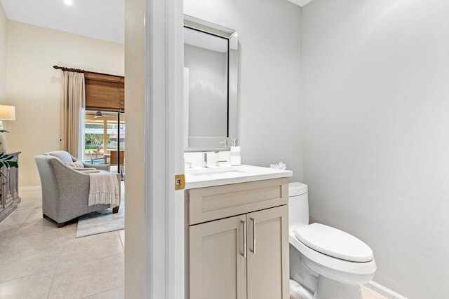 bathroom with tile patterned flooring, vanity, and toilet