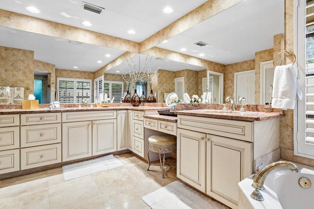 bathroom featuring vanity, tile patterned flooring, and a relaxing tiled tub