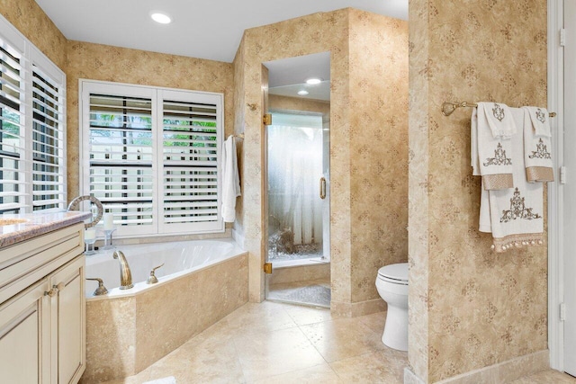 full bathroom featuring vanity, independent shower and bath, and toilet