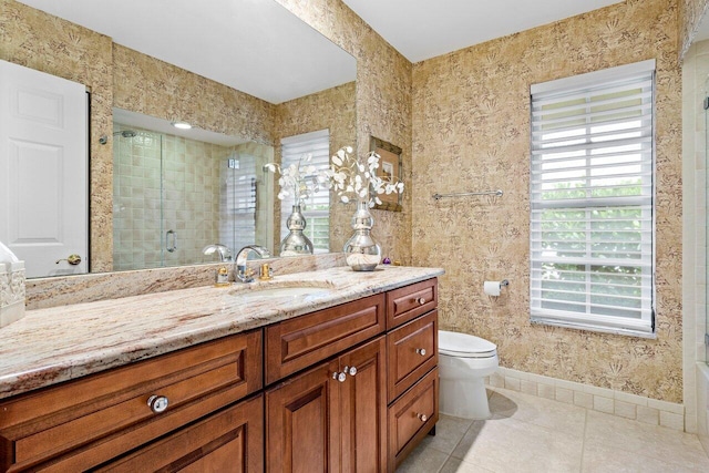 bathroom with tile patterned flooring, vanity, a shower with shower door, and toilet