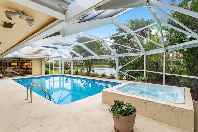 view of pool featuring an in ground hot tub, a water view, glass enclosure, and a patio area