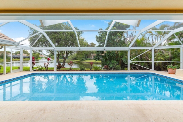 view of pool with a water view and glass enclosure