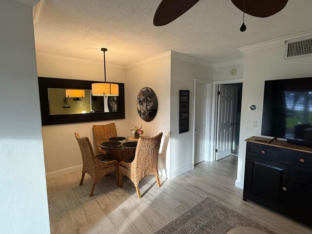 bedroom with ceiling fan, ensuite bath, a spacious closet, ornamental molding, and a closet