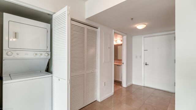 clothes washing area with stacked washer / drying machine