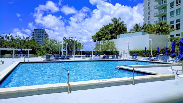 view of pool with a pergola and a patio area