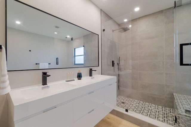 bathroom with an enclosed shower, vanity, and hardwood / wood-style flooring