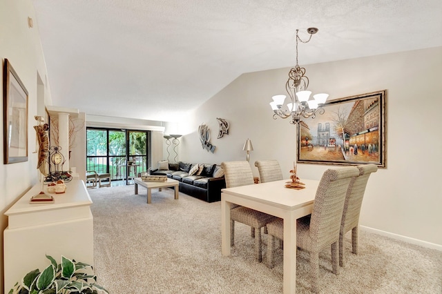 dining area featuring an inviting chandelier, baseboards, lofted ceiling, and carpet