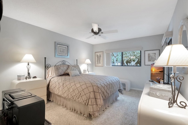 bedroom featuring baseboards, light carpet, and a ceiling fan