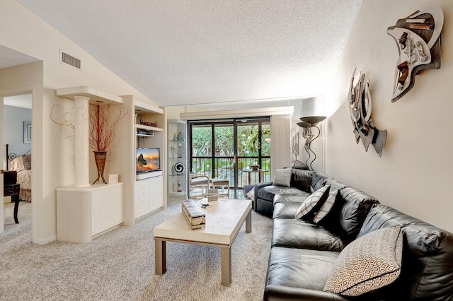 living room featuring visible vents, built in features, lofted ceiling, carpet flooring, and a textured ceiling