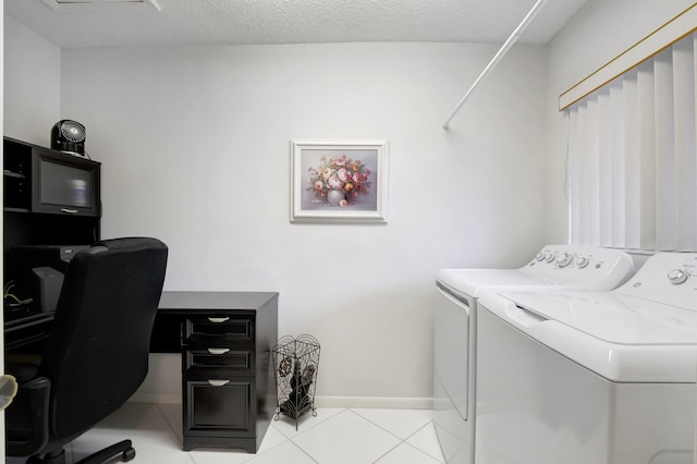 washroom featuring baseboards, laundry area, light tile patterned flooring, washer and dryer, and a textured ceiling