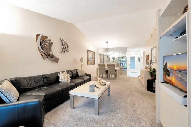 carpeted living area featuring a notable chandelier, a textured ceiling, and vaulted ceiling