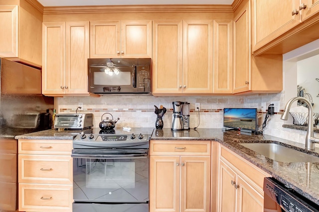 kitchen featuring a sink, decorative backsplash, black appliances, and light brown cabinetry